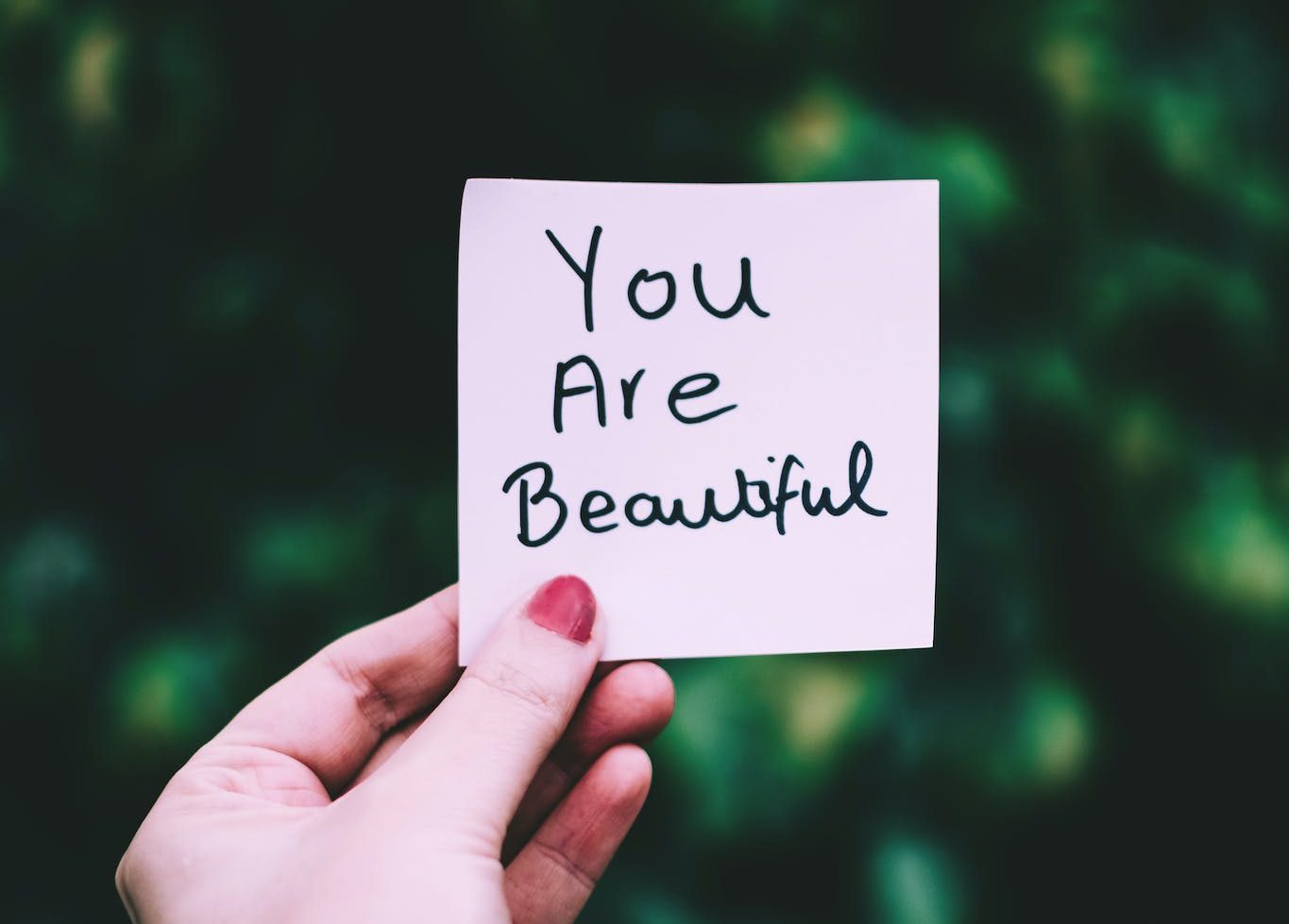 Person Holding a Sticky Note that says "you are beautiful".