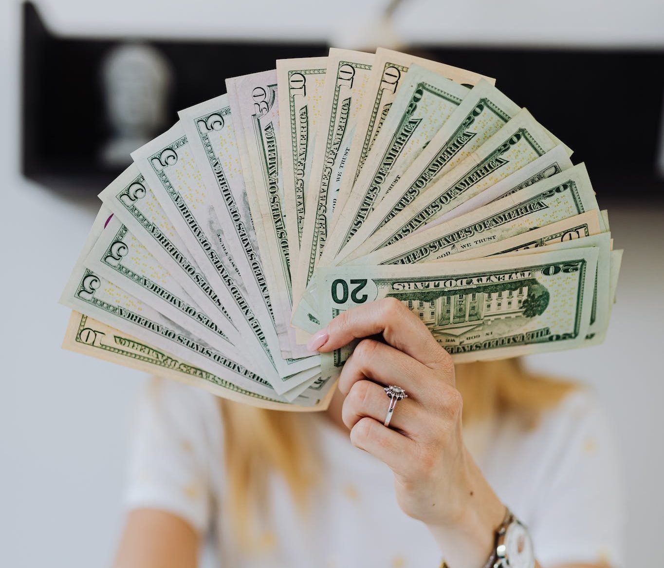 Person Holding Fan of Us Dollar Bills.