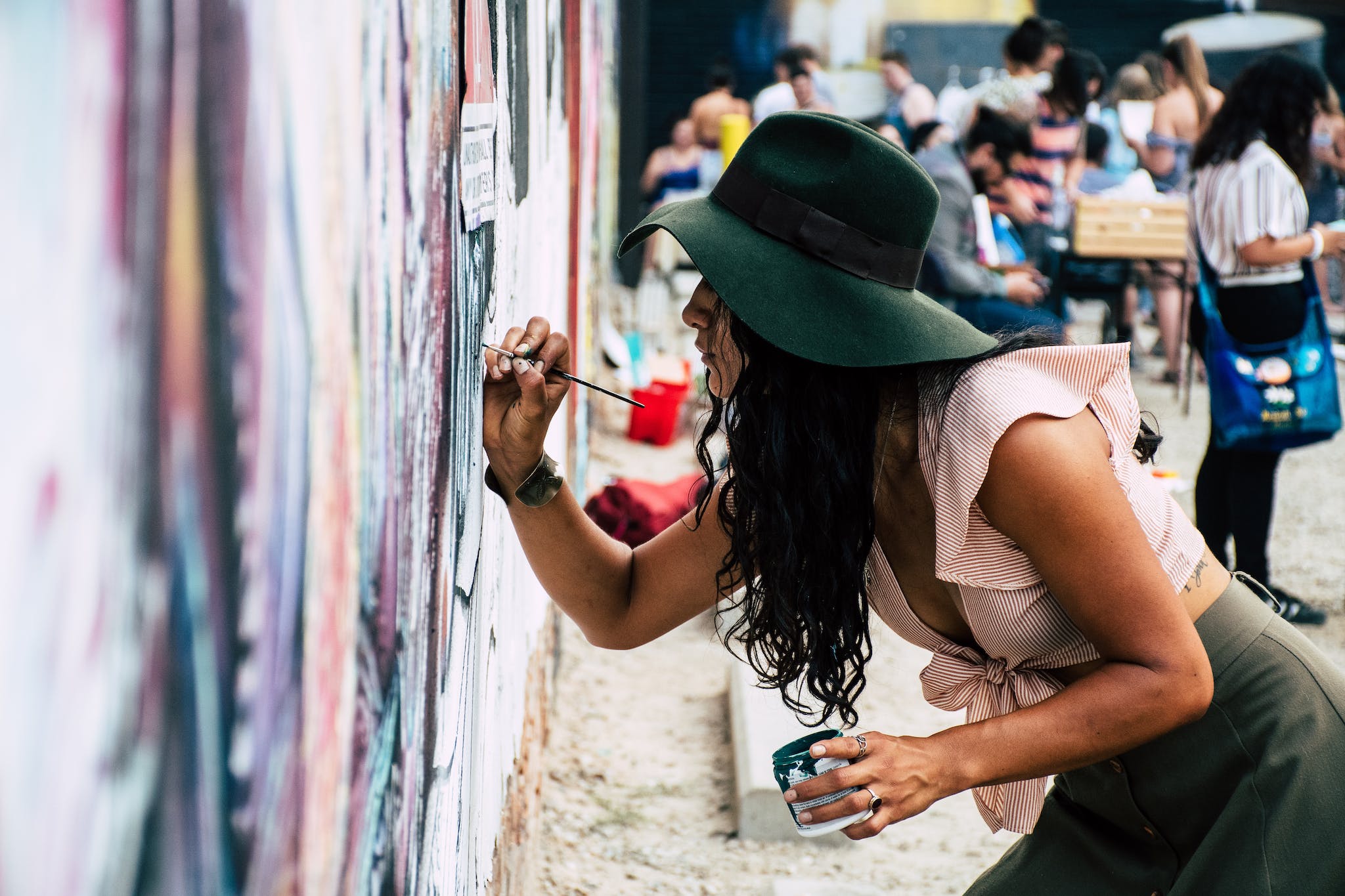 Photo of Woman Painting on Wall.