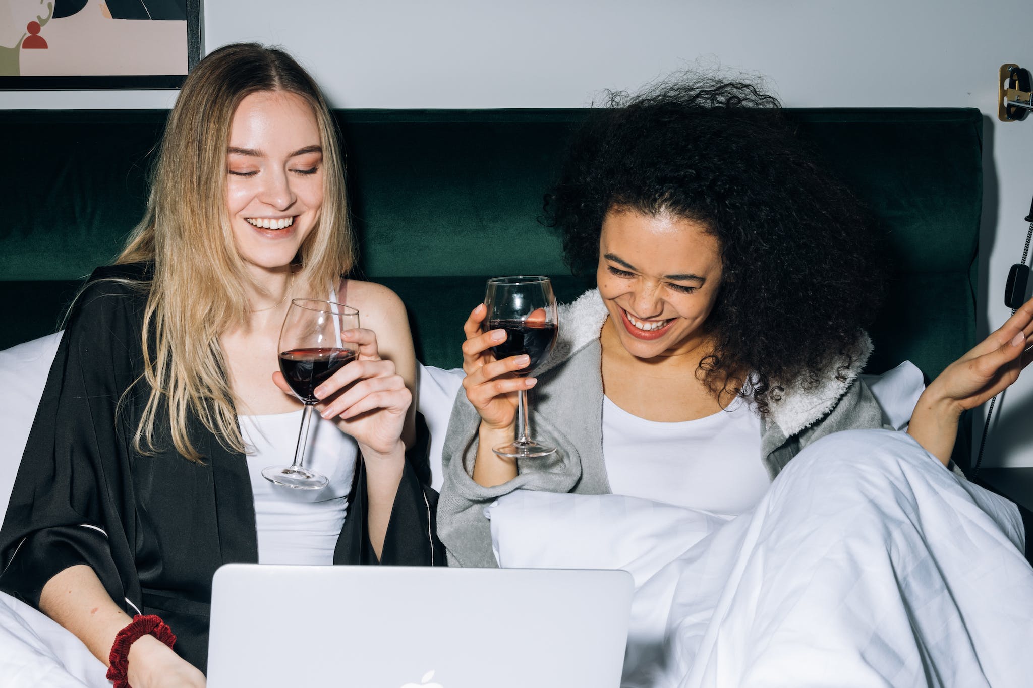 Two Young Women Having Fun While Looking at a Laptop.